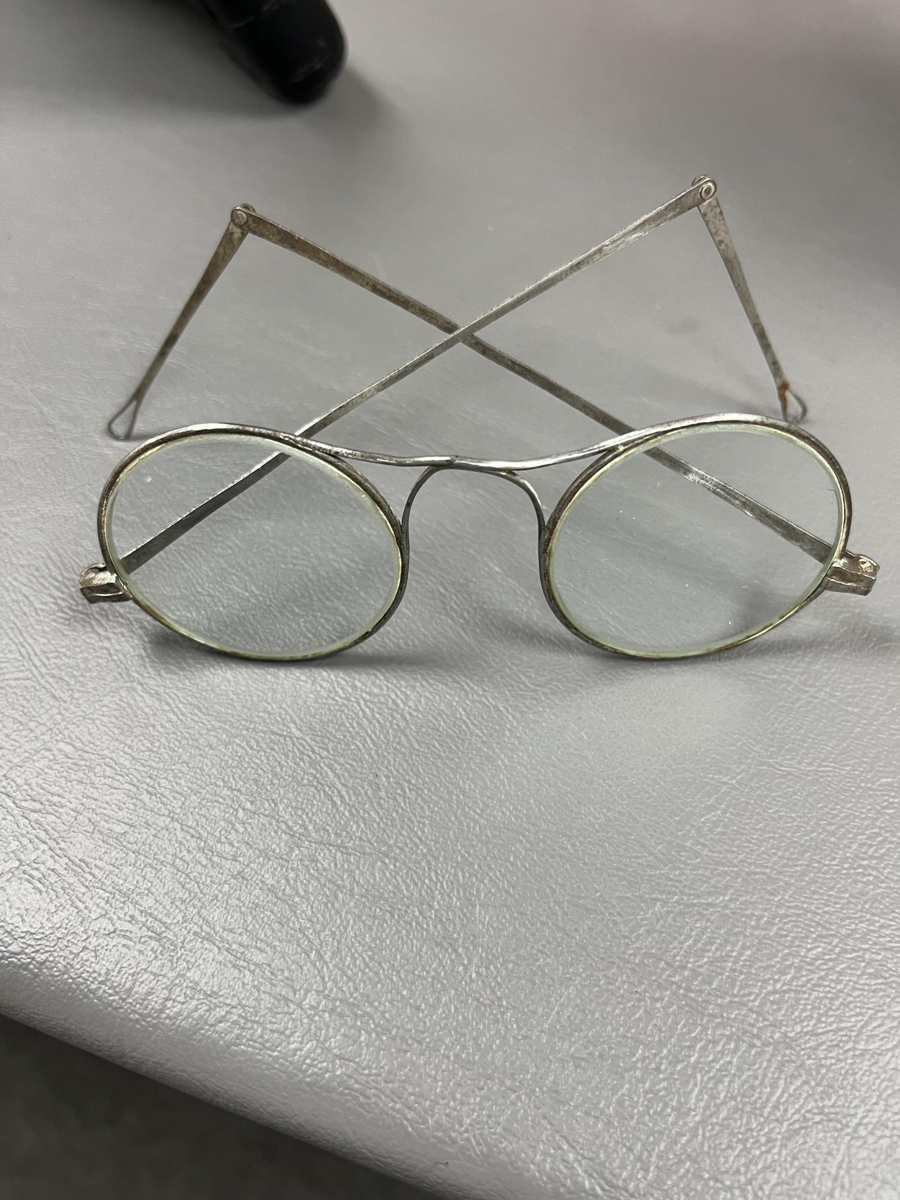 A collection of 19th/20th century Chinese embroidered silk spectacle cases and various spectacles, Box 33cm square